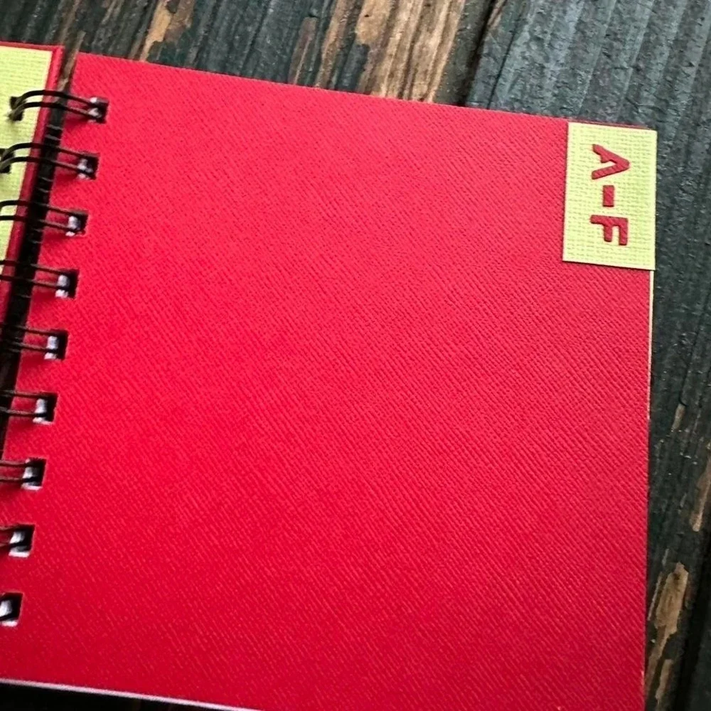 Red and yellow spiral website address book with ribbon